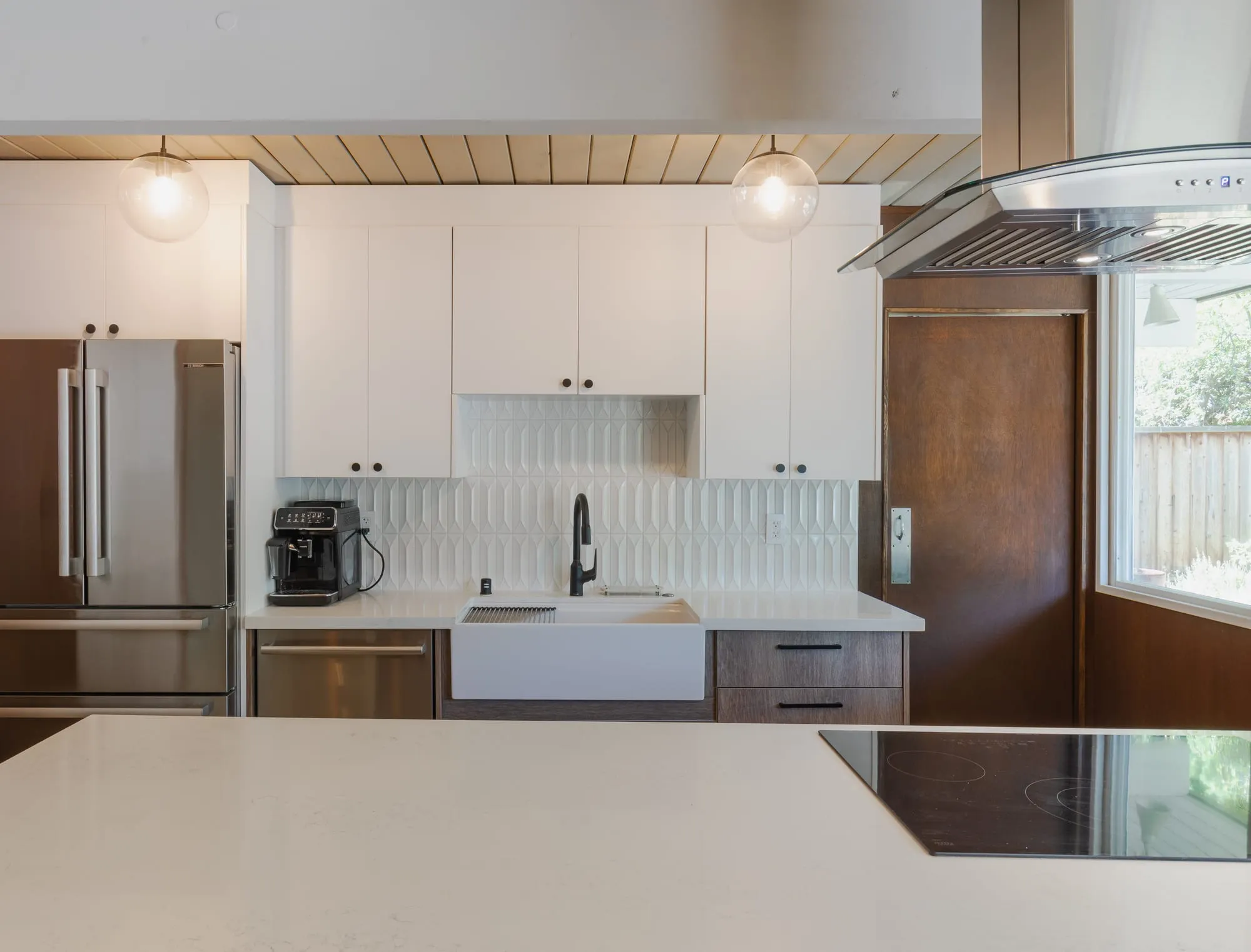 Apron sink against the white fluted tile backsplash