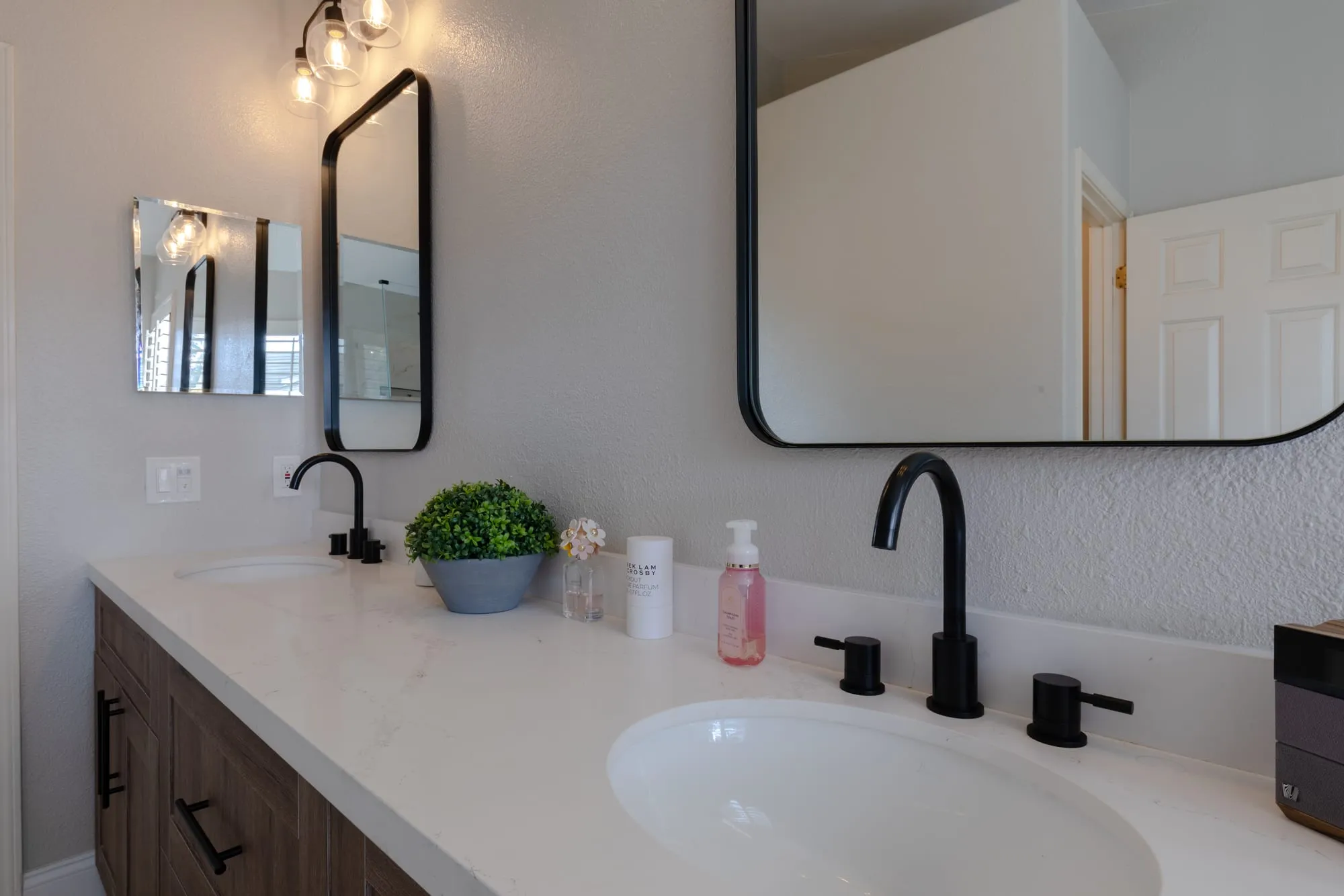 Basin with a matte black tap on the quartz counter