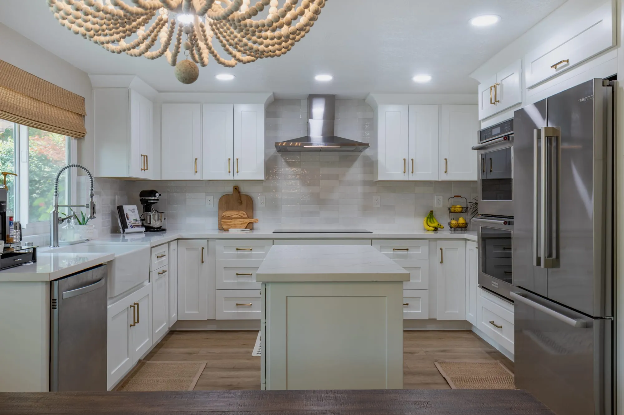 Beaded wood chandelier hanging over the island in front of the kitchen run
