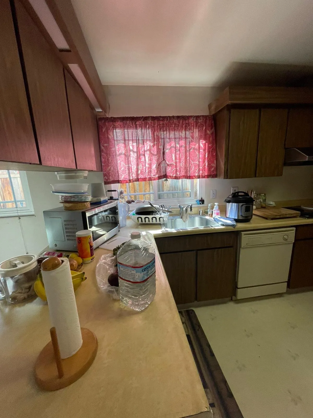 Original kitchen before remodel, dark timber cabinets and tiled counters
