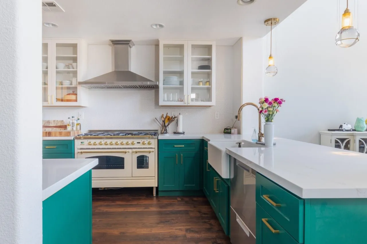 Brass gooseneck tap at the apron sink with the white quartz peninsula in front