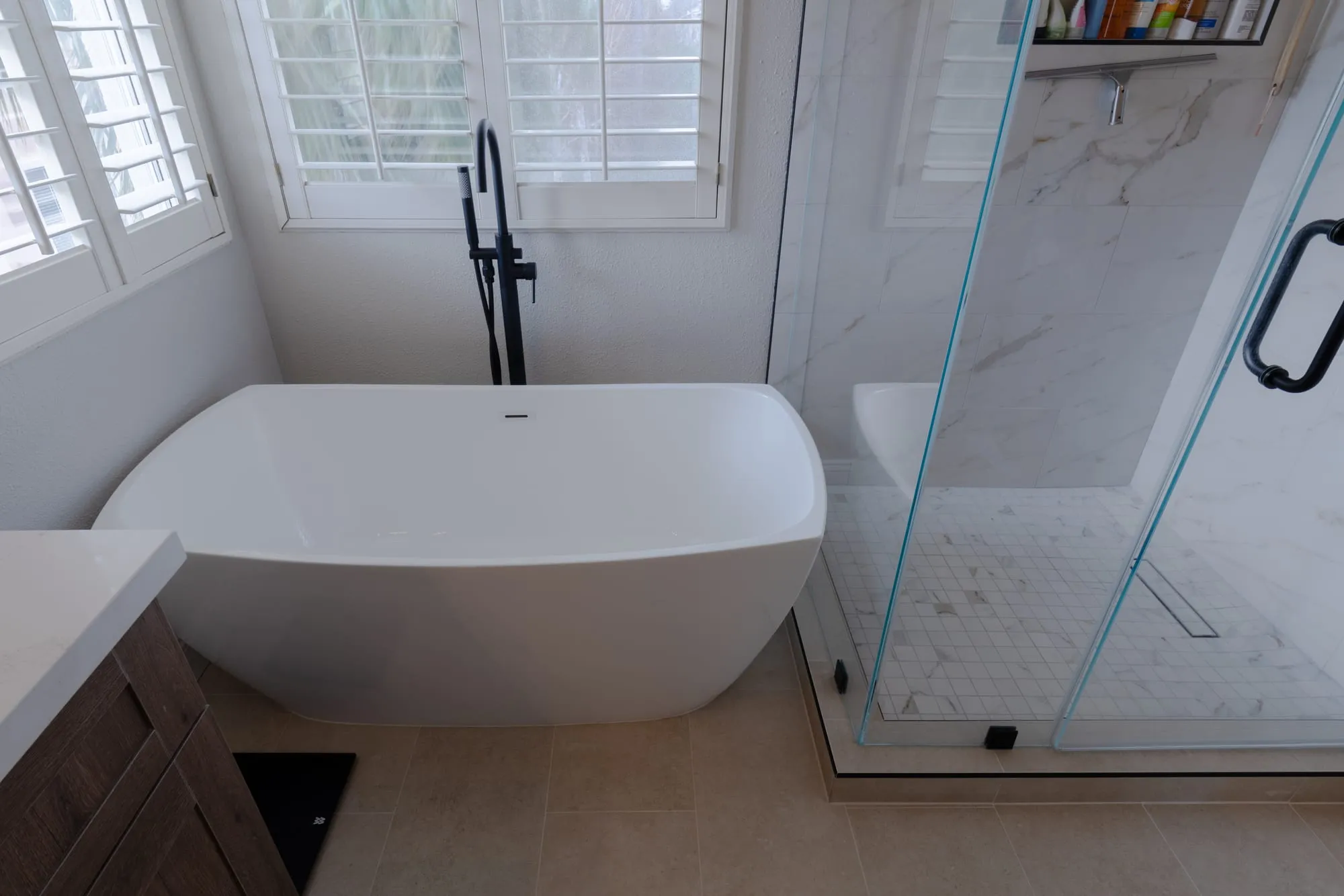 Freestanding tub beside the glass shower