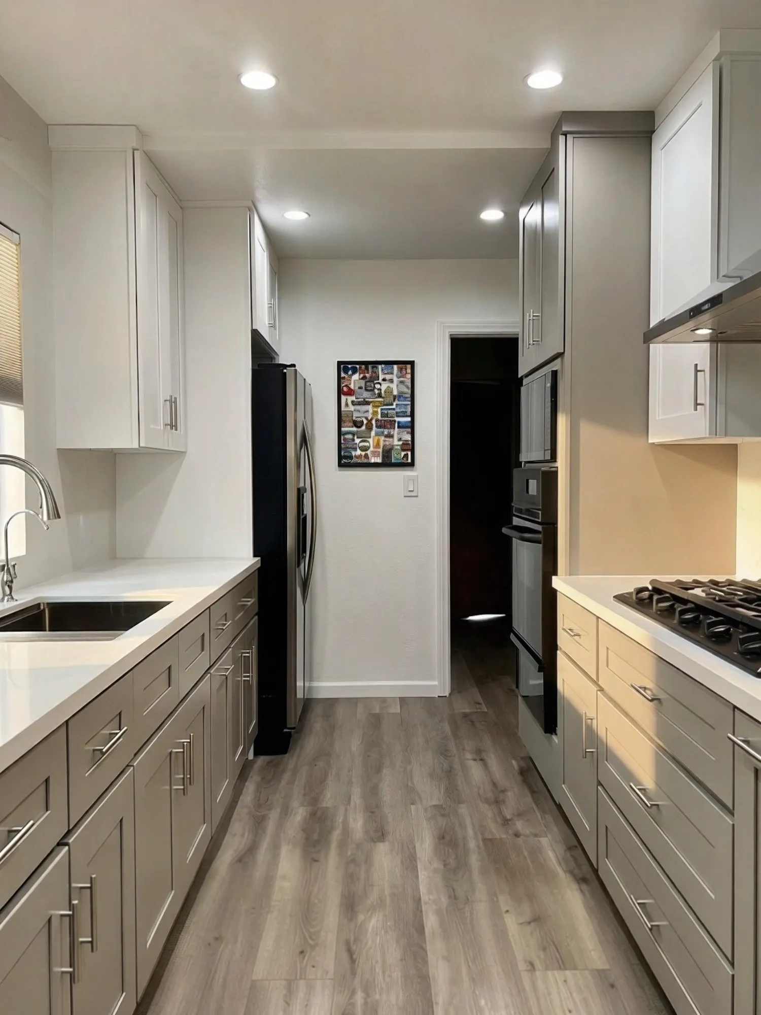 Galley toward the doorway, upper cabinets and quartz counters on both sides