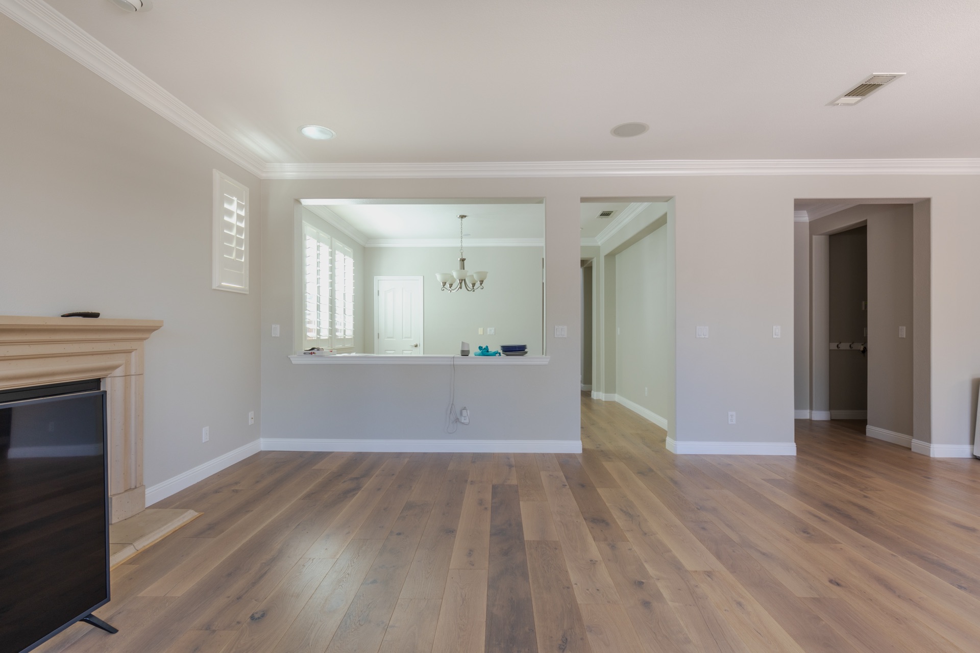 Whole-home remodel — open living area with fireplace and passageway to dining