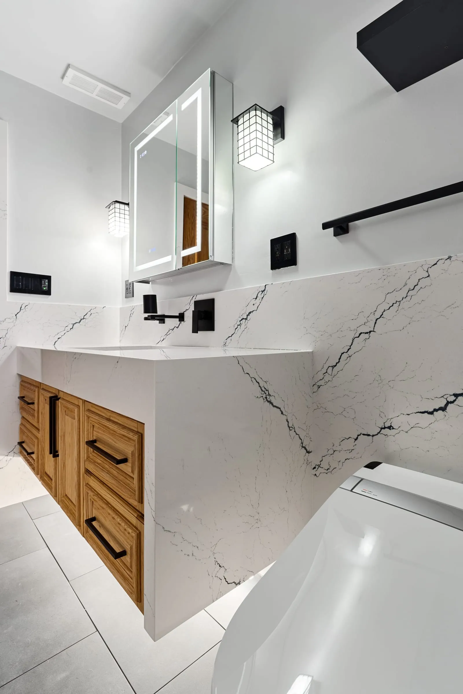 Oak vanity with a quartz top and an integrated basin