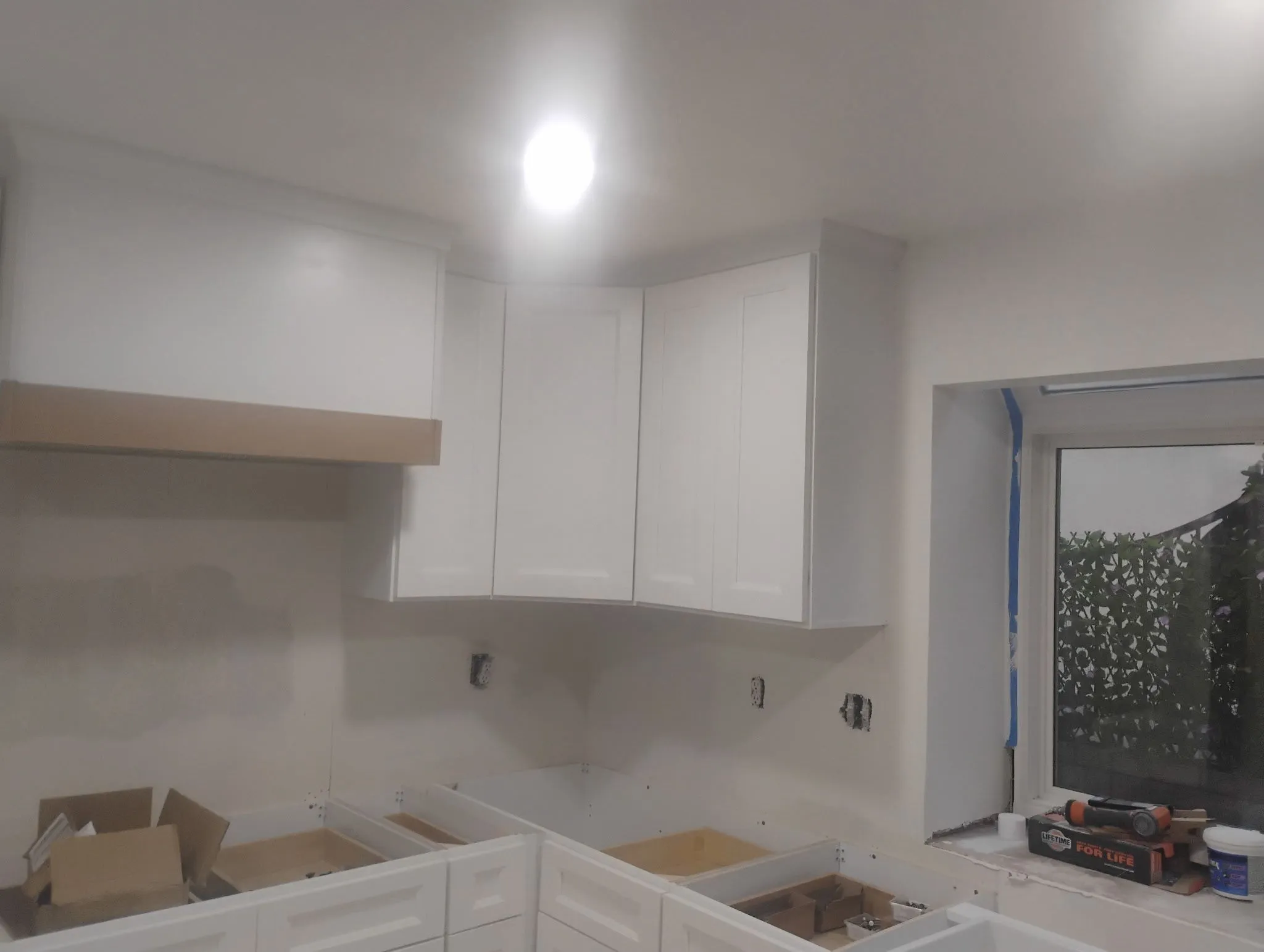 The same range wall before remodel, stripped back before hood cladding, tile and counters