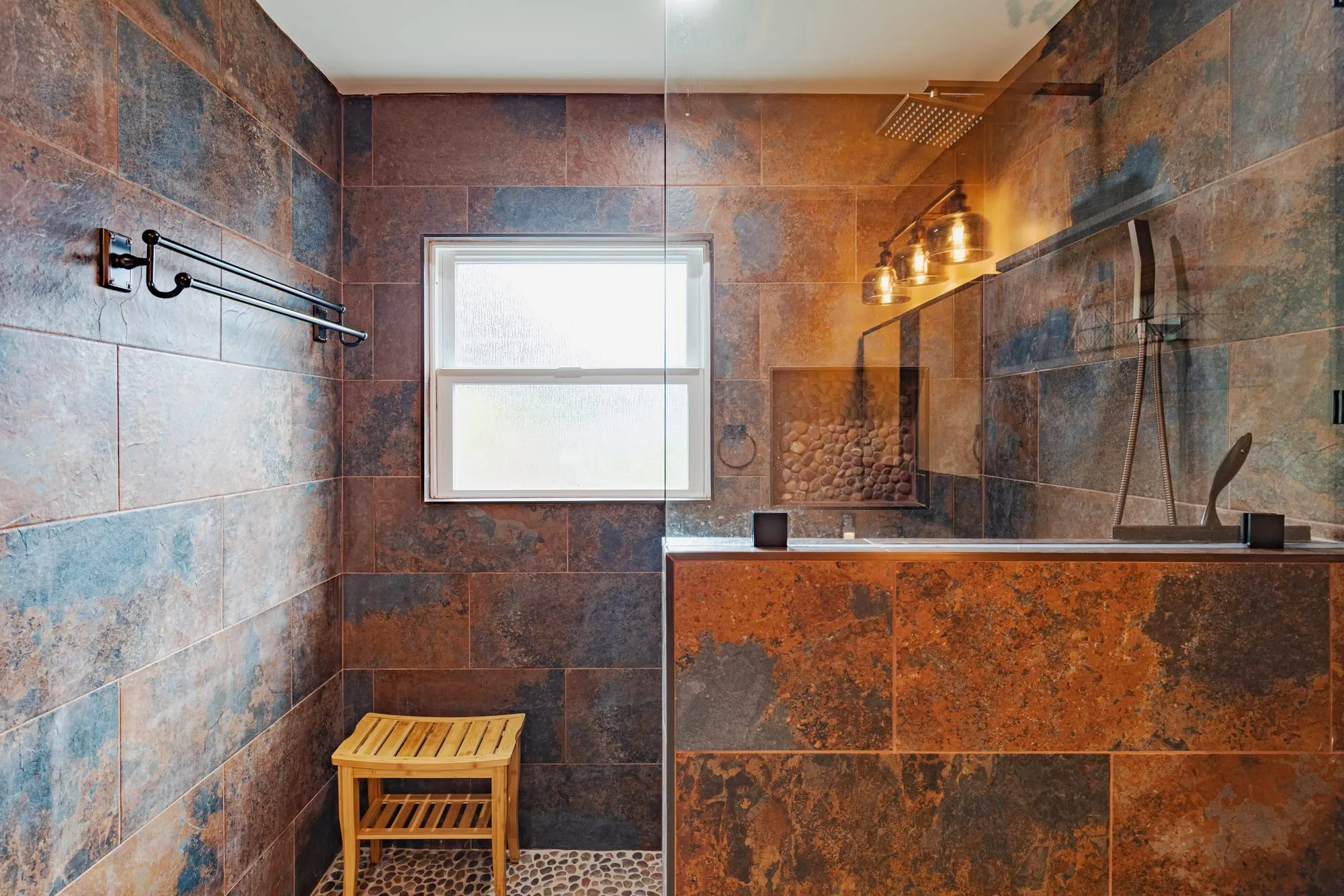 Shower with a teak bench below the window