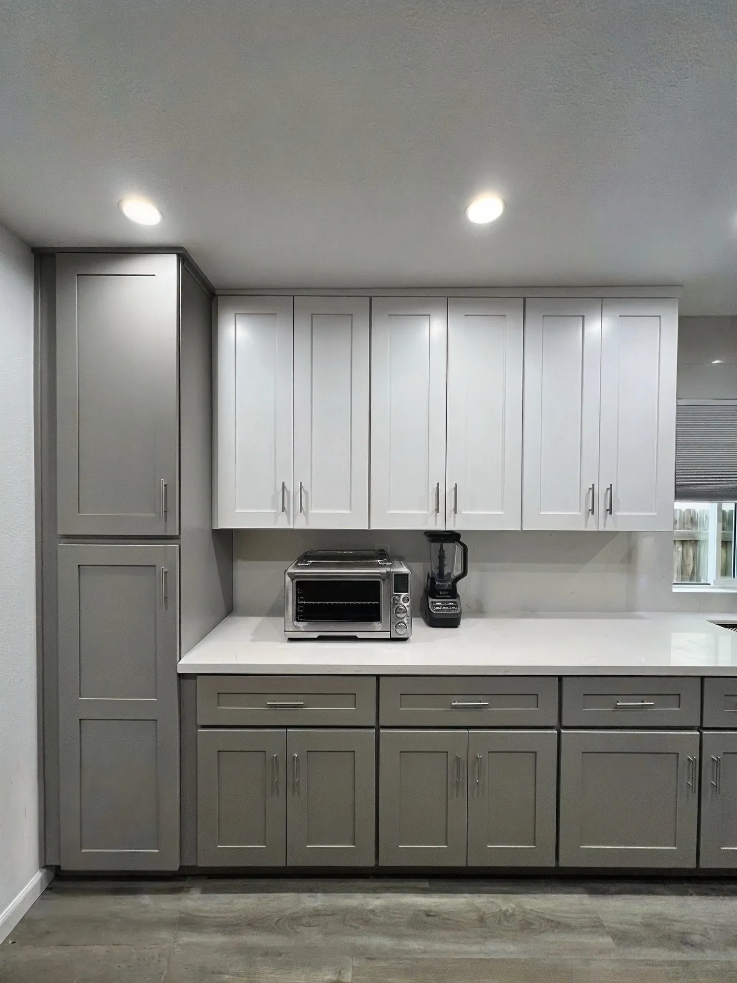 Tall cabinet wall with the built-in microwave and ovens
