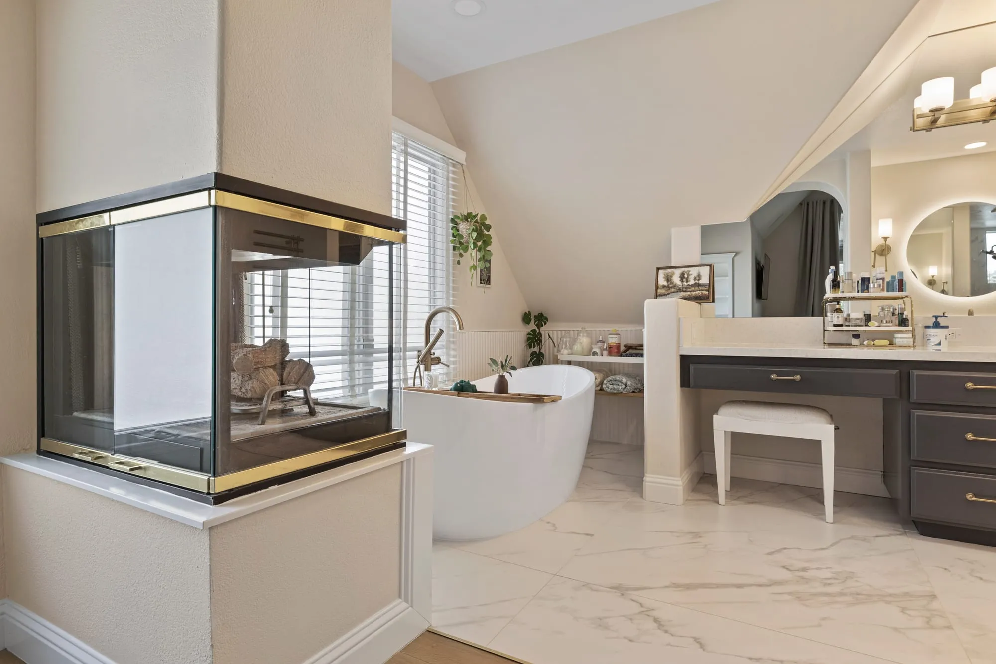 Wide view of the tub and fireplace under the vaulted ceiling