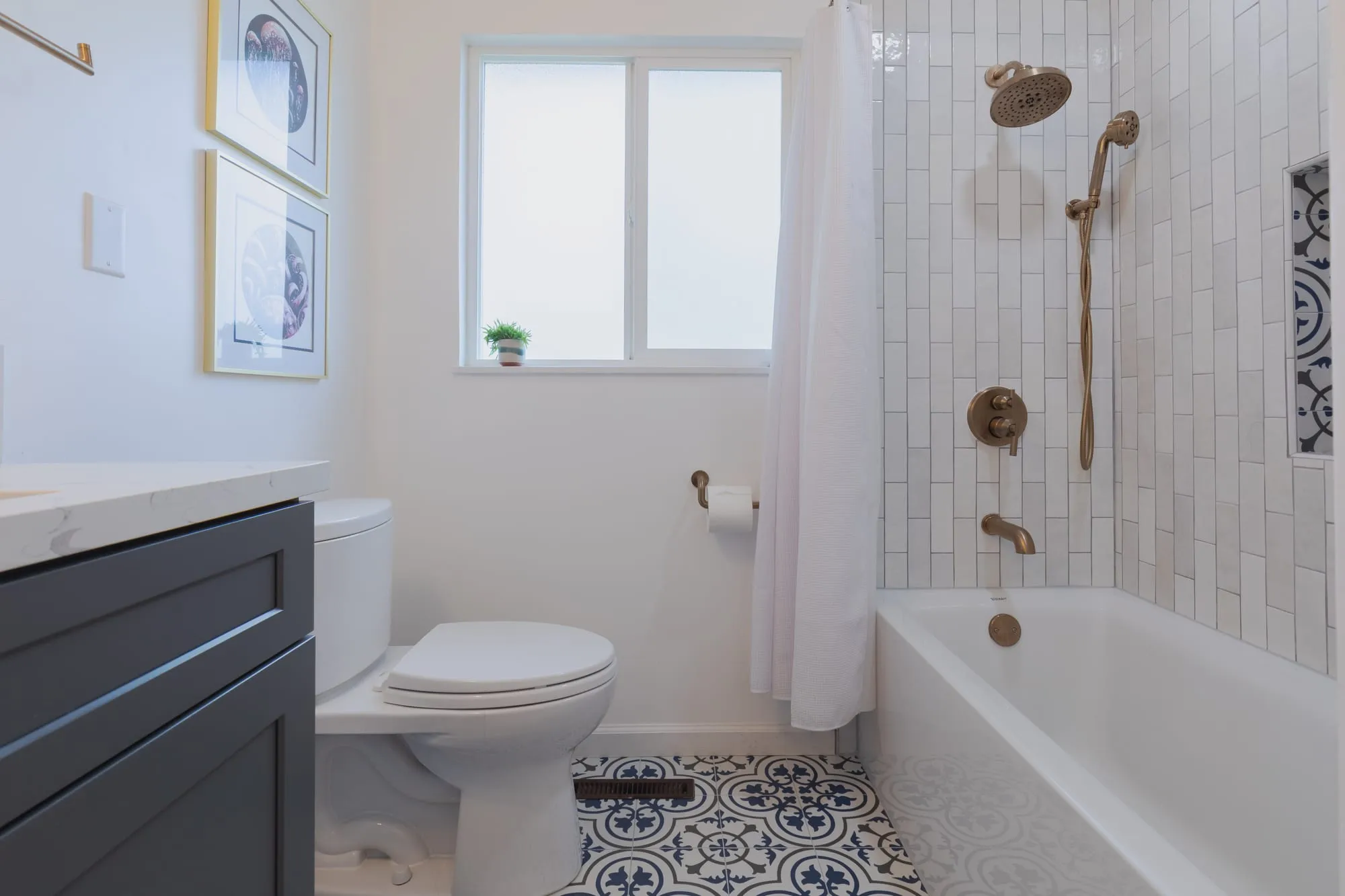 Alcove tub and window with stacked white tile around it