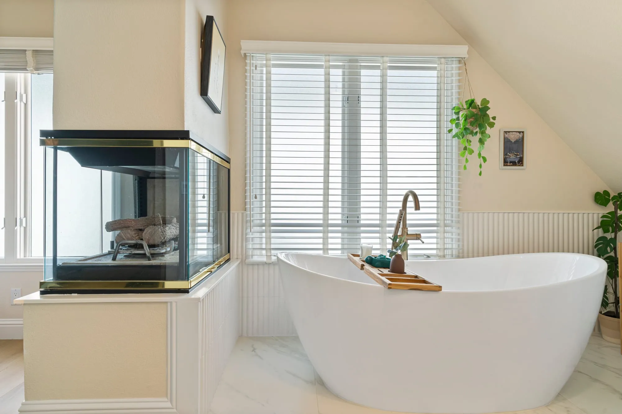 Freestanding tub beside the see-through fireplace