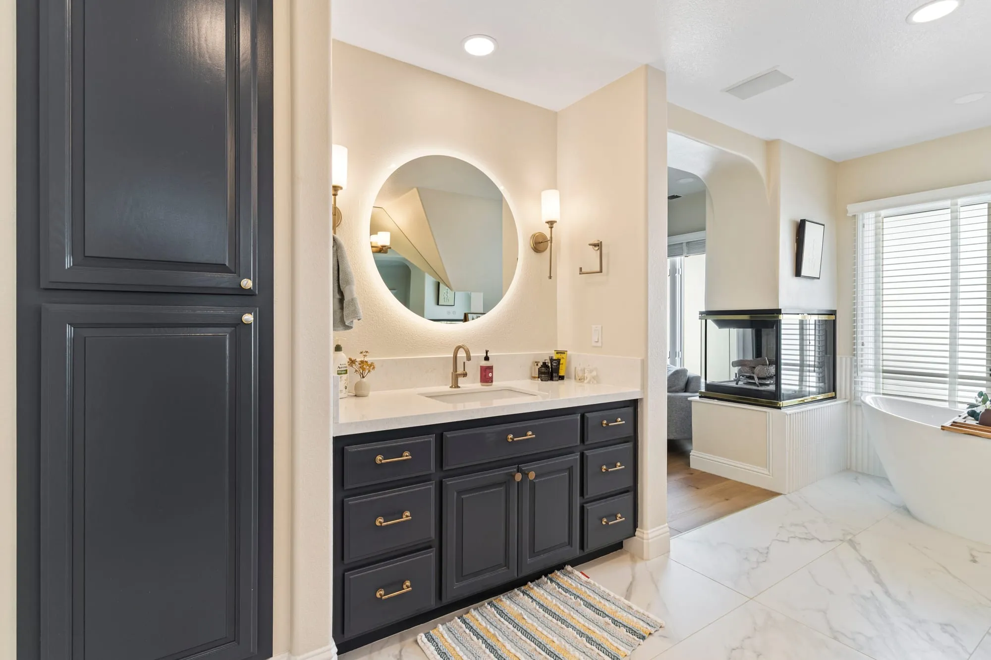 Navy tall cabinet beside the vanity