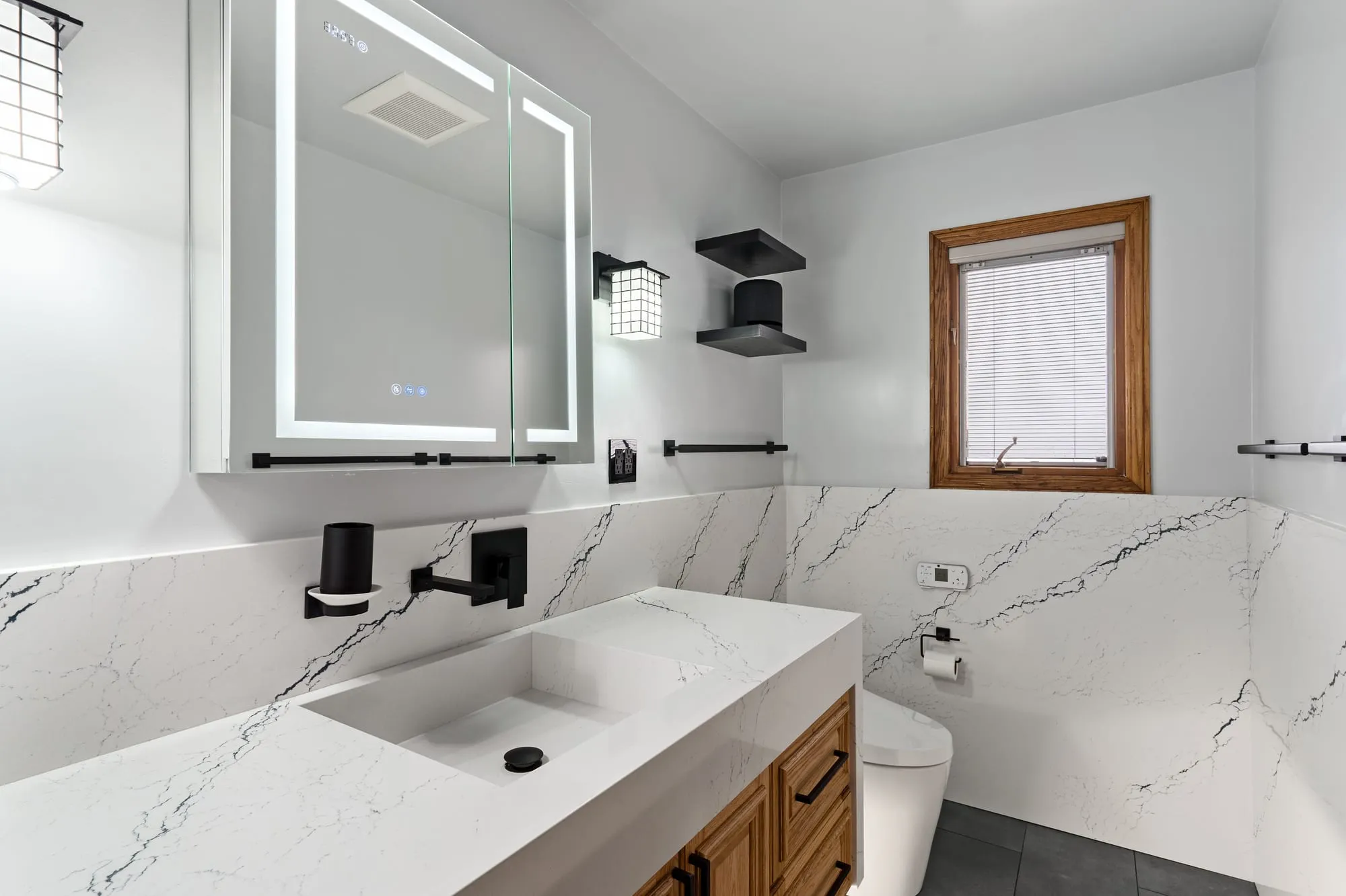 Basin and mirror with matte black wall-mounted taps