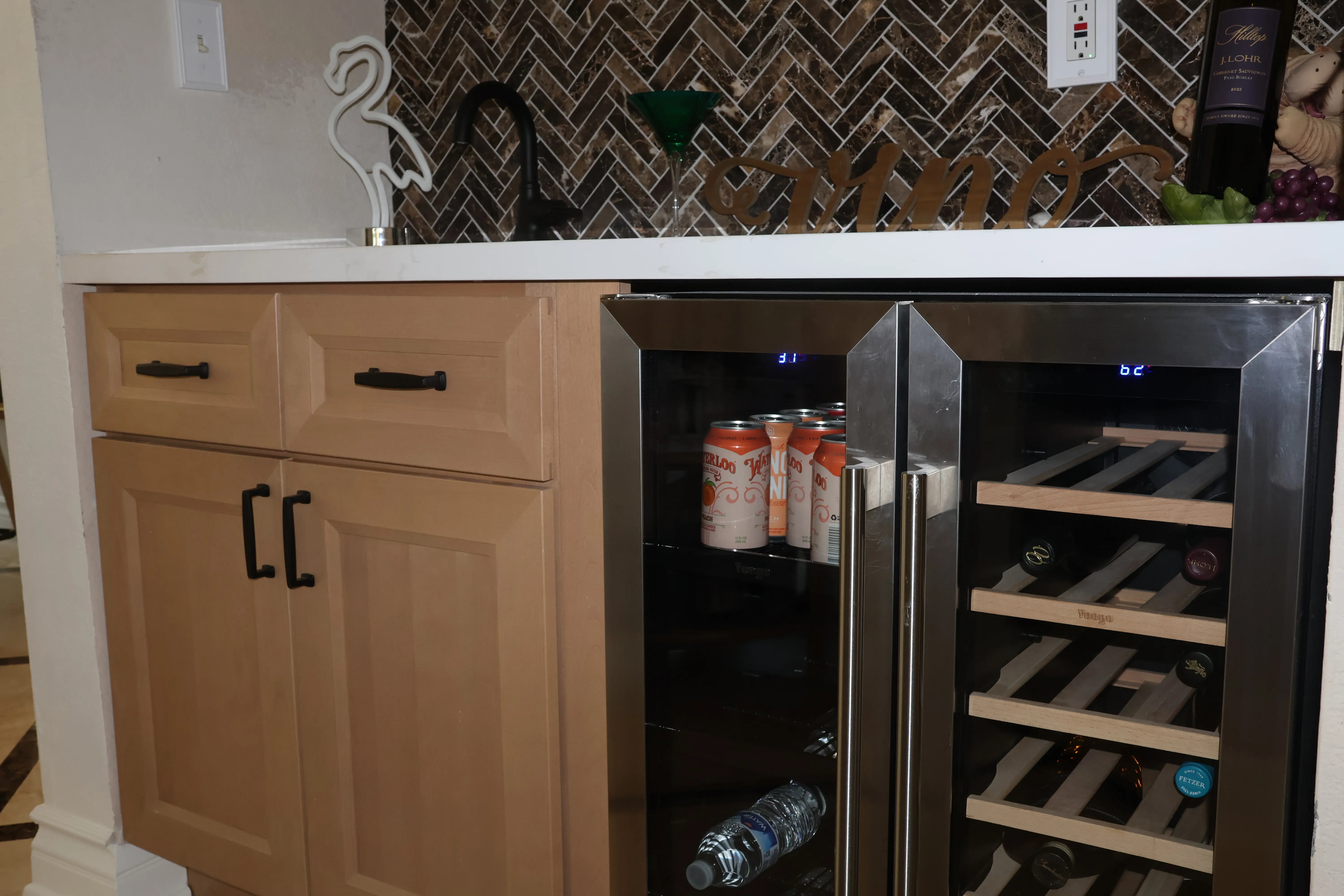 Tucked wine bar in brown herringbone tile with two glass-fronted wine fridges
